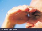 close-up-of-man-shielding-eyes-from-sun-A26390.jpg