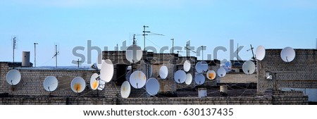 stock-photo-a-lot-of-satellite-and-cable-television-antennas-are-located-on-the-rooftop-of-a-multi-storey-630137435.jpg